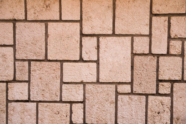 A brick wall displaying a series of square shapes, creating a visually interesting and structured appearance.